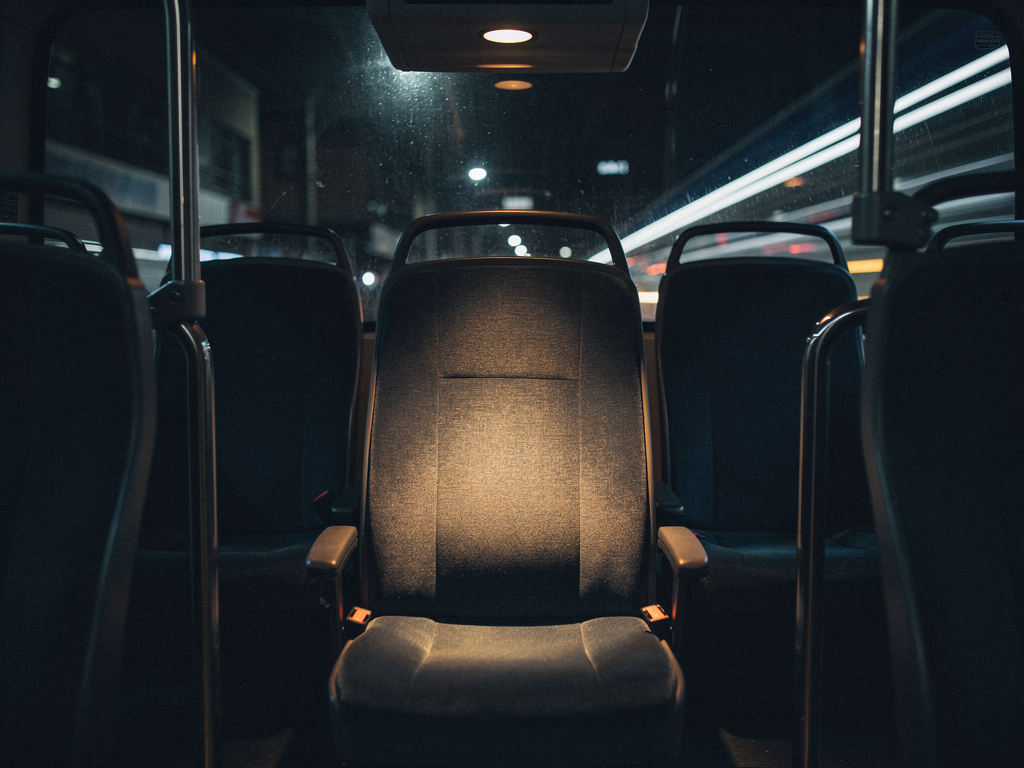 Empty seat on a night bus with soft overhead light